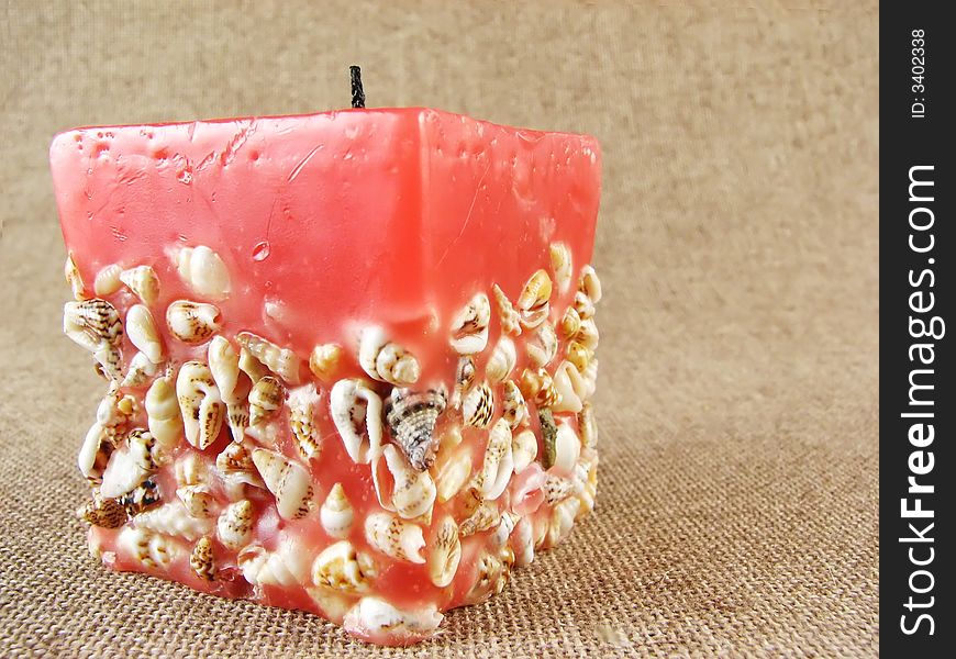 Home series: red candle on beige tissue