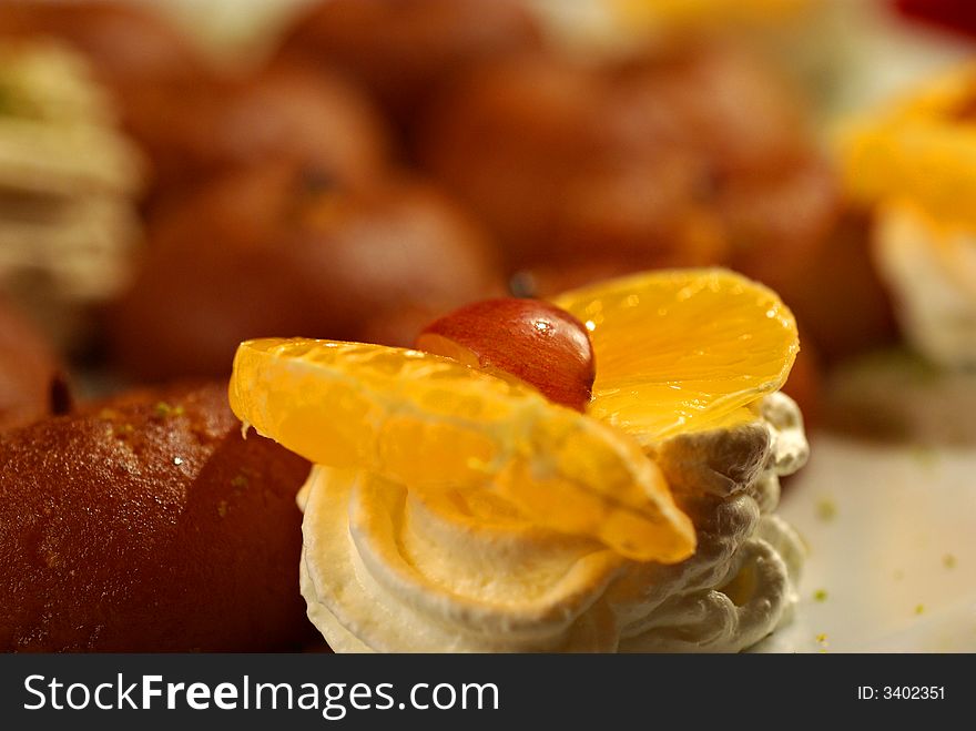 Wedding cake with orange and cream - all in front of an oriental, romantic background. Wedding cake with orange and cream - all in front of an oriental, romantic background