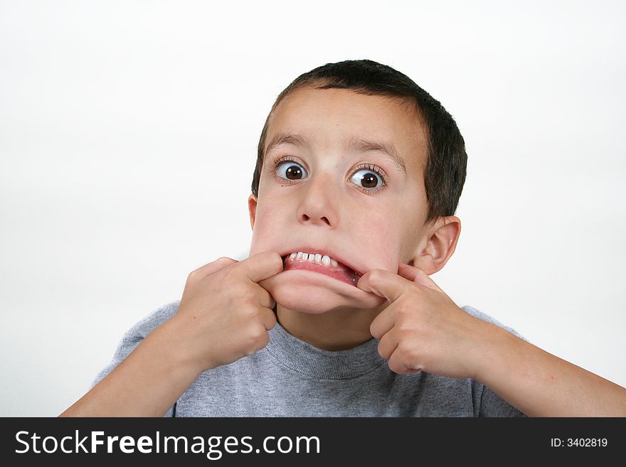 A young boy making a scary face