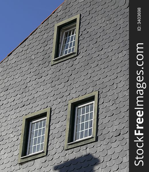 Detail of a house facade with windows and tiles