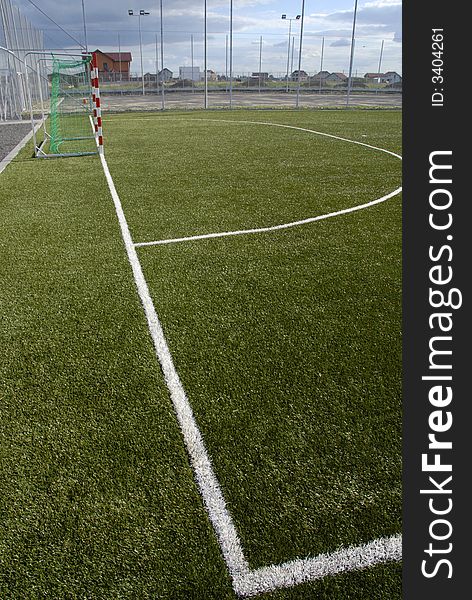 Side view of an empty green soccer field