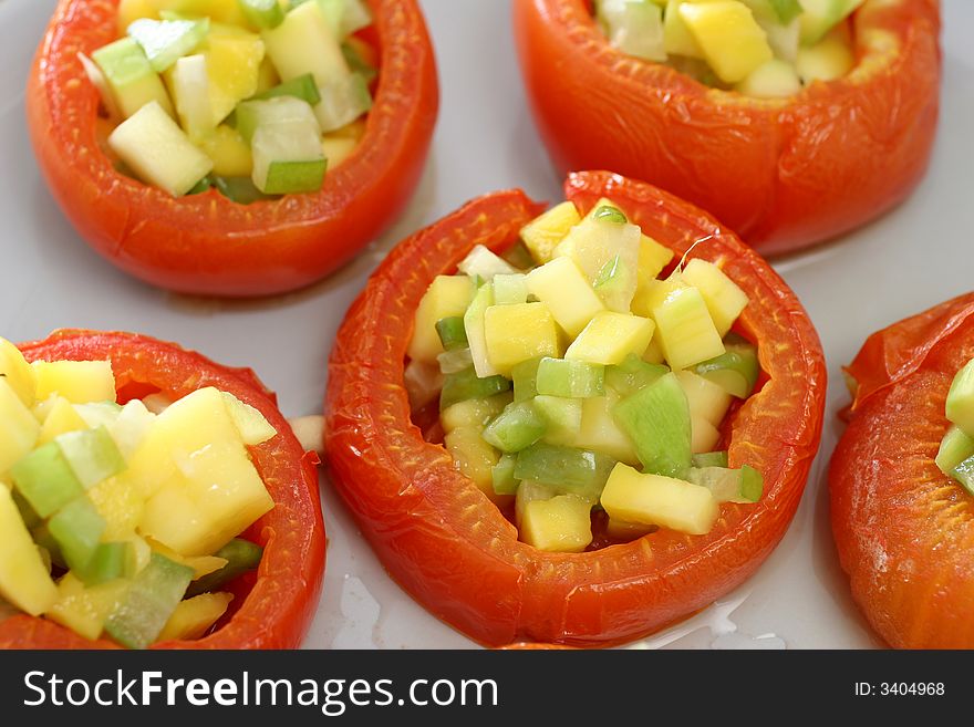 Large carved baked tomatoes with miniature mango and star fruit filling. Large carved baked tomatoes with miniature mango and star fruit filling