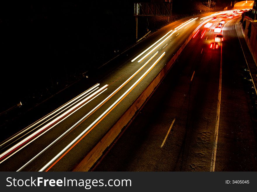 Busy freeway with streaks of lights from the headlights and tail lights of the cars. Busy freeway with streaks of lights from the headlights and tail lights of the cars