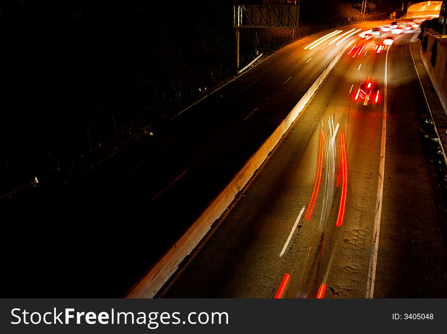 Busy freeway with streaks of lights from the headlights and tail lights of the cars. Busy freeway with streaks of lights from the headlights and tail lights of the cars