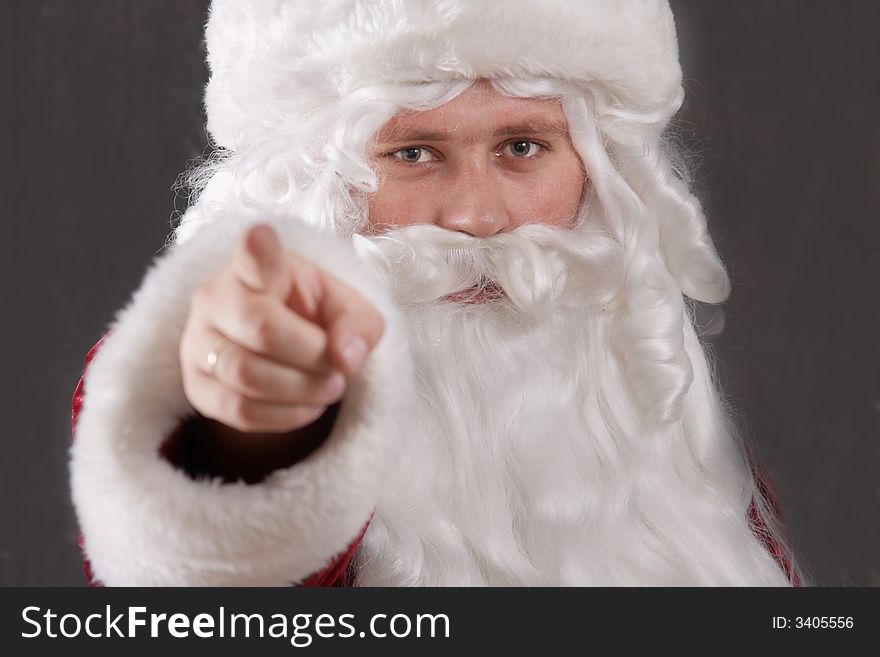 An inage of Santa Claus showing his forefinger. An inage of Santa Claus showing his forefinger