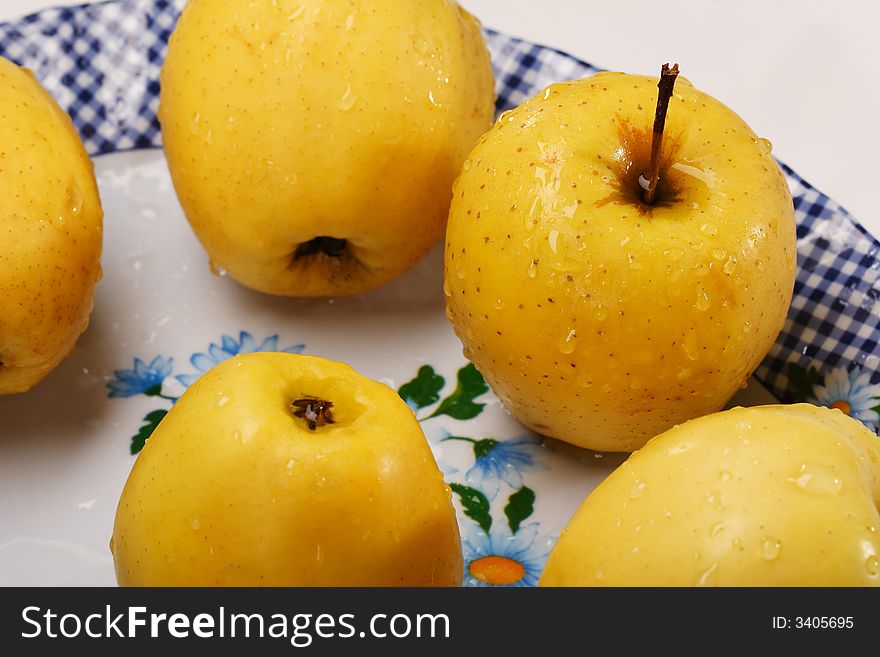 Yellow apples on the plate
