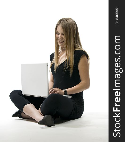 Woman sitting on floor with white laptop computer on her lap. Woman sitting on floor with white laptop computer on her lap.