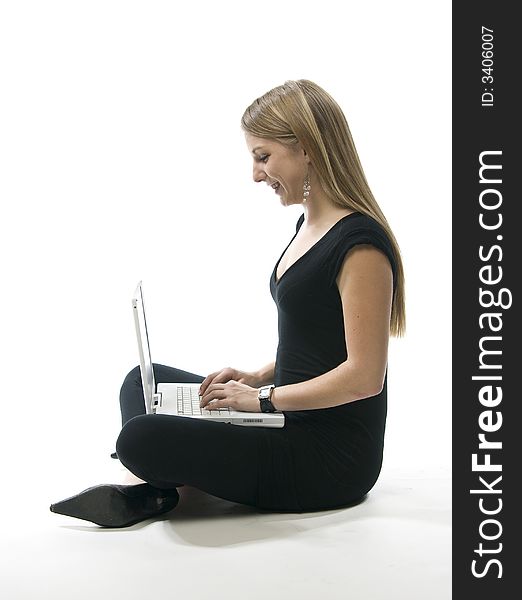 Woman sitting on floor with a white laptop computer. Woman sitting on floor with a white laptop computer.