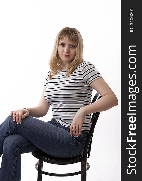 Woman sitting on a chair isolated on white