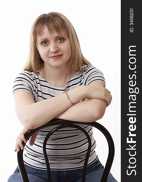 Woman sitting on a chair isolated on white