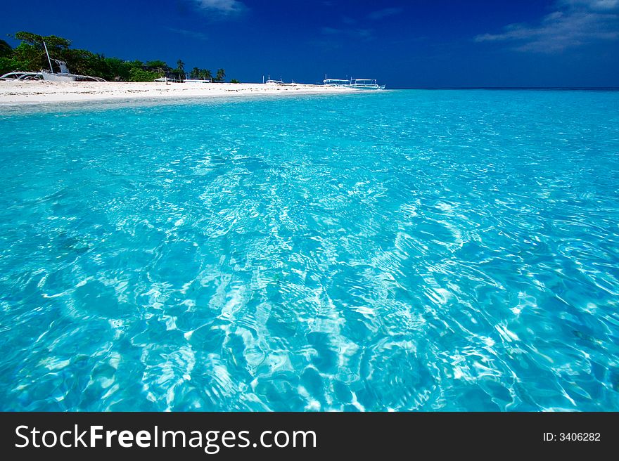 Ocean View of beautiful pacific blue water beside a tropical island with white sand. Ocean View of beautiful pacific blue water beside a tropical island with white sand