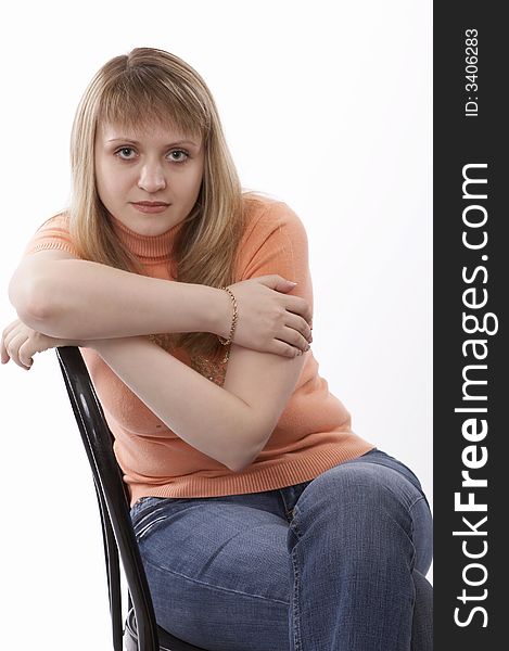 Woman sitting on a chair isolated on white