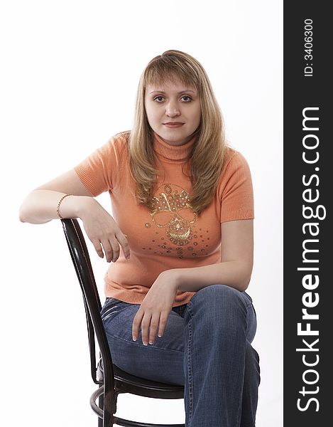 Woman sitting on a chair isolated on white