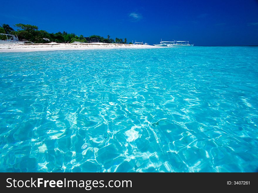 Ocean View of beautiful pacific blue water beside a tropical island with white sand. Ocean View of beautiful pacific blue water beside a tropical island with white sand