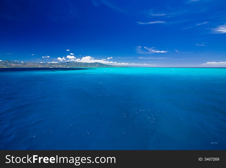 Ocean view of beautiful caribbean blue water beside a secluded white sand beach. Ocean view of beautiful caribbean blue water beside a secluded white sand beach