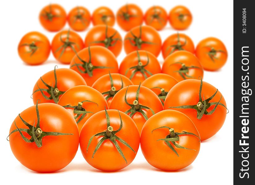 Close up of a pile of red round tomatoes on white background. Close up of a pile of red round tomatoes on white background.