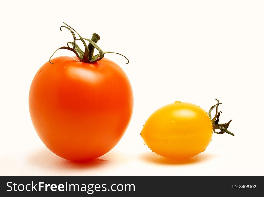 Close up of a red round and a yellow football like tomatoes on white background. Close up of a red round and a yellow football like tomatoes on white background