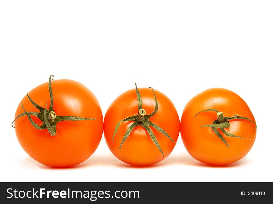 Three top viewed red round tomatoes lying on the same plane on white background. Three top viewed red round tomatoes lying on the same plane on white background