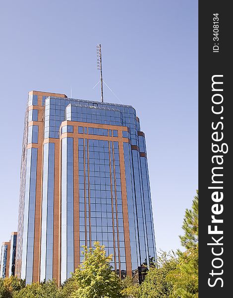 A modern brick and glass office building against blue sky. A modern brick and glass office building against blue sky