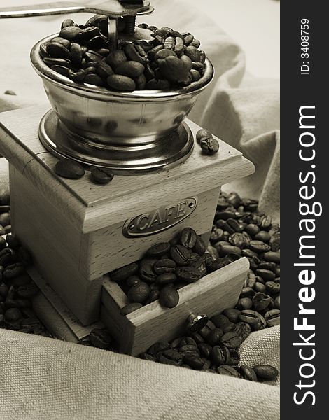 Coffee background: Close-up of a beans, cup, mill. Coffee background: Close-up of a beans, cup, mill