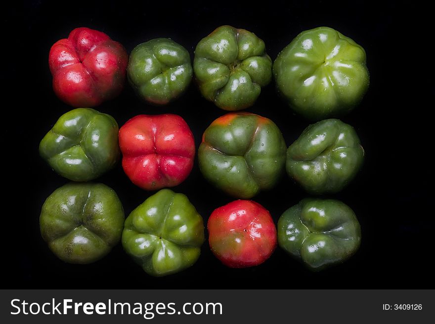 Red and green  bellpeppers composition over black