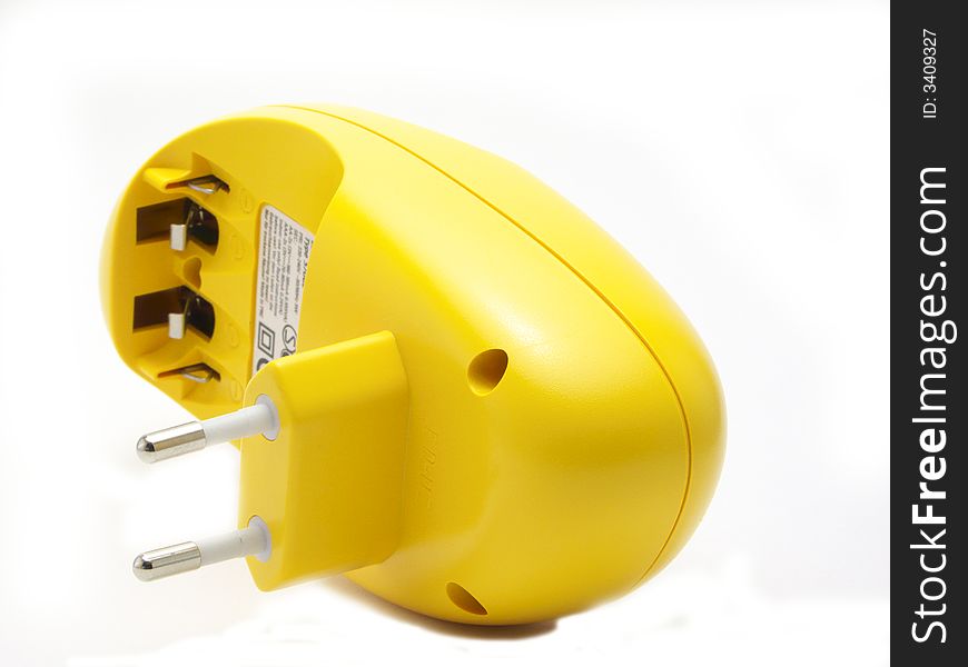 Charger for AA and AAA batteries. The yellow color. Isolated on a white background