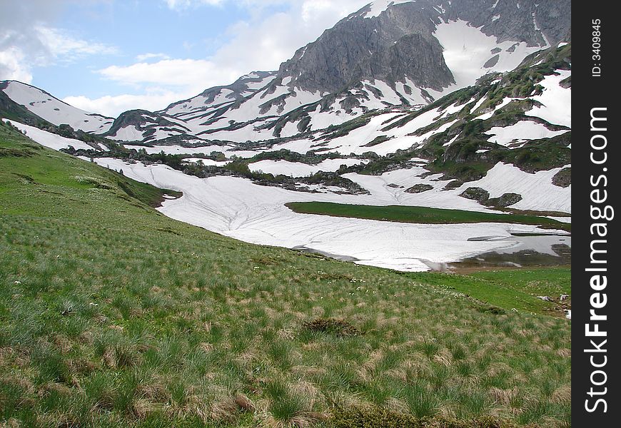 Lake  under snow. 
Sacred lake of Adighes.
On a background the mountain pass is visible.
June 2007. Lake  under snow. 
Sacred lake of Adighes.
On a background the mountain pass is visible.
June 2007