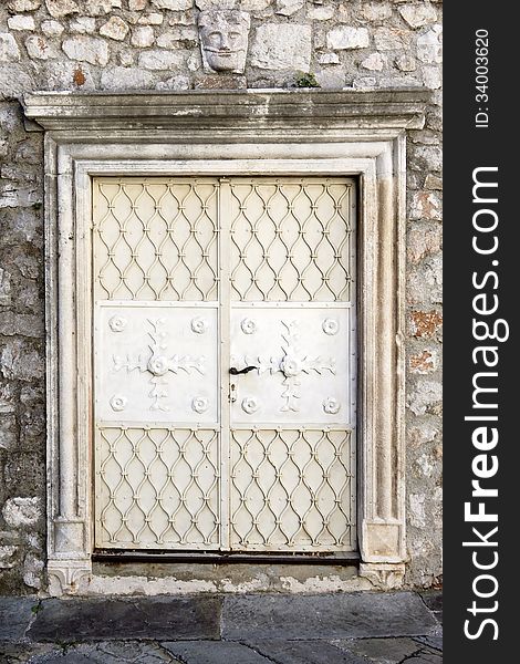 Old decorated white doors in natural stone building. Old decorated white doors in natural stone building