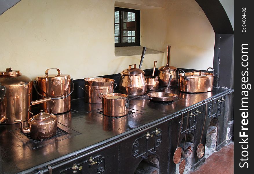 Copper Saucepans on a Large Vintage Cooking Range.