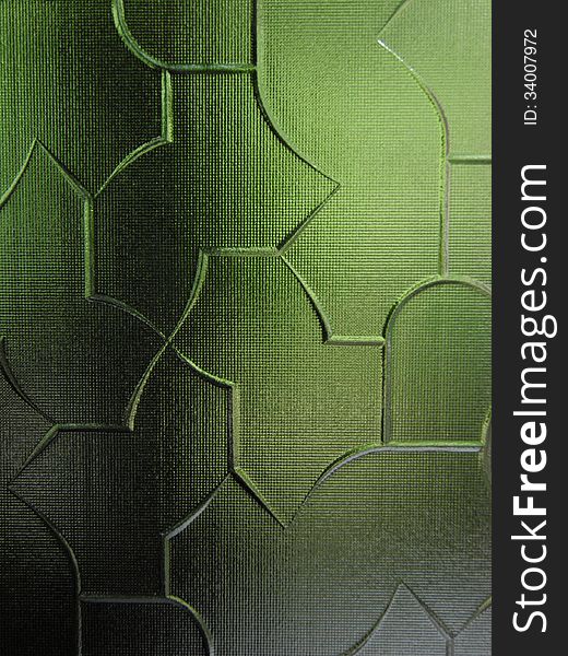 A part from a sandblasted green colored glass with variate geometric forms. A part from a sandblasted green colored glass with variate geometric forms.