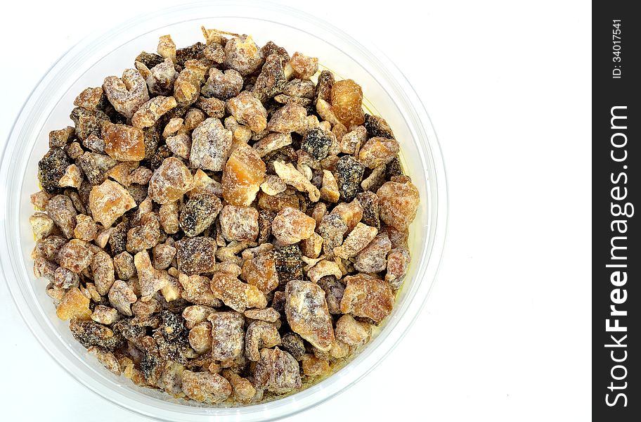 A bowl of chopped dates on a white background.