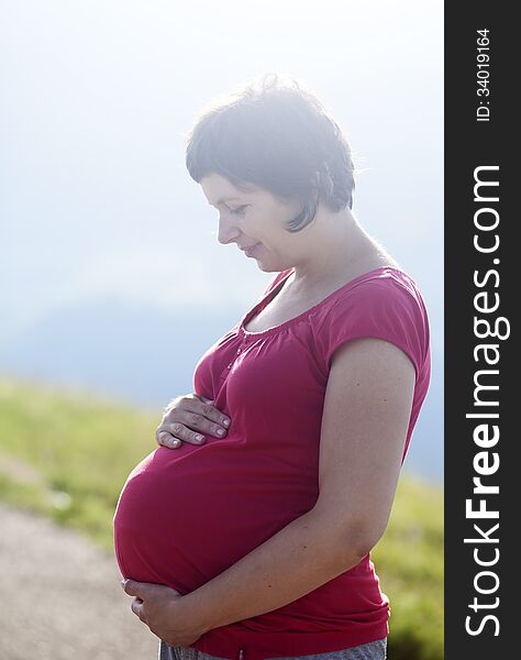 Pregnant Happy Woman In A Flowering Poppy Field