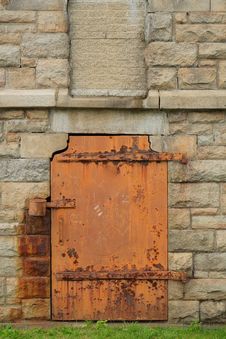 Rustic Metal Door In Stone Wall Royalty Free Stock Photos