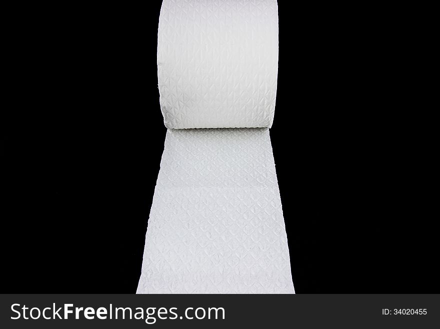 White toilet paper roll isolated on black background