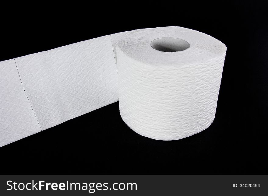 White toilet paper roll isolated on black background