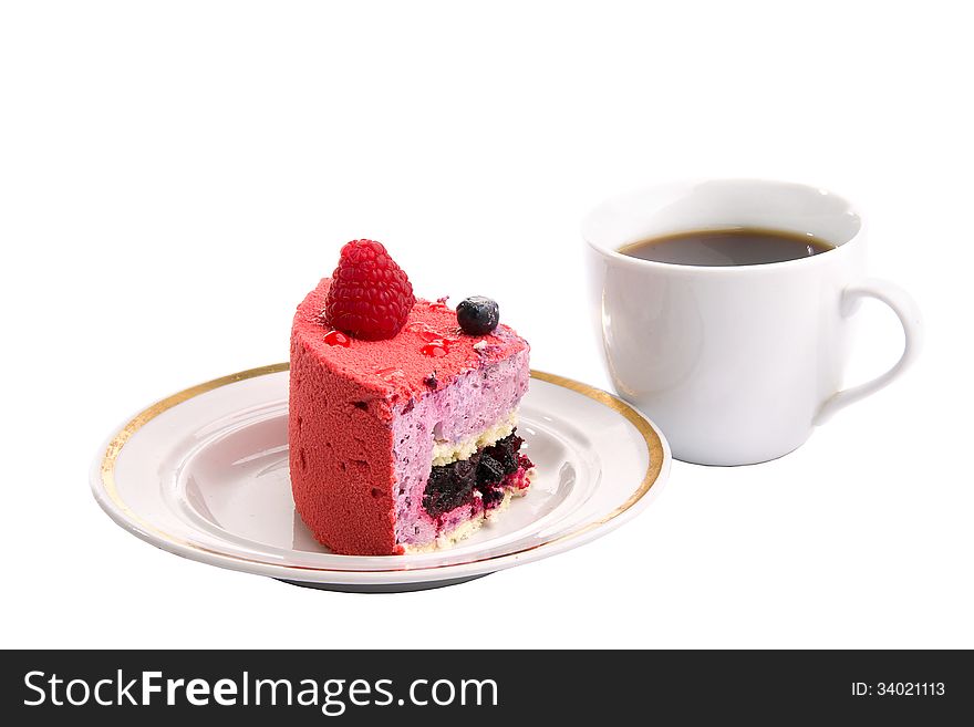 Piece of blueberry raspberry cake with a cup of tea next