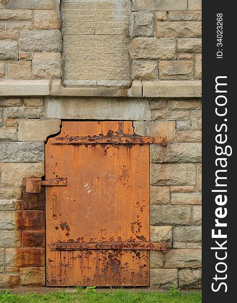 Rustic Metal Door in Stone Wall