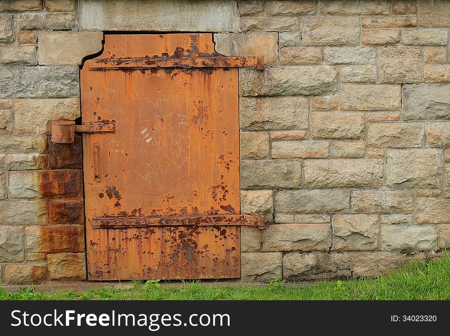 Rustic Metal Door in Stone Wall