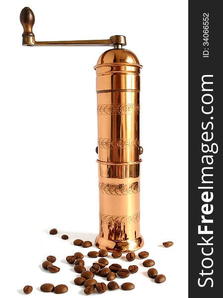 Vintage copper coffee grinder with coffee beans and shadows