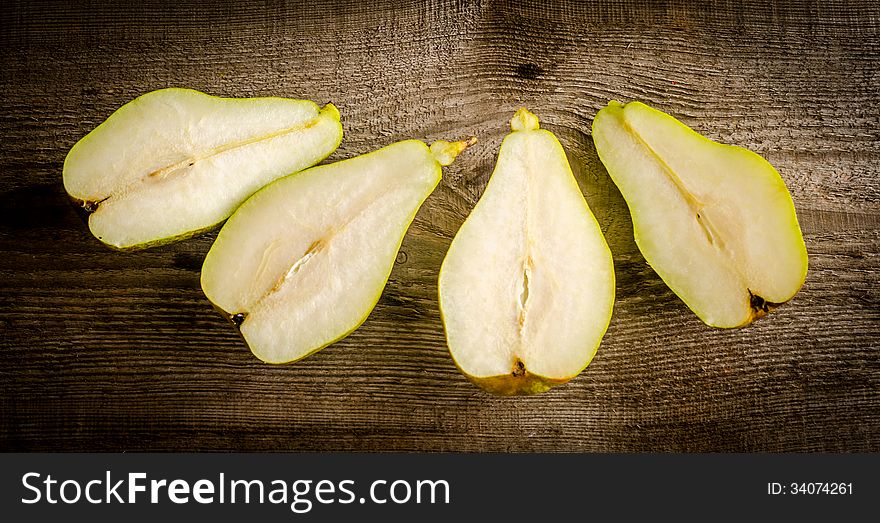 Sliced green pears on the wooden table