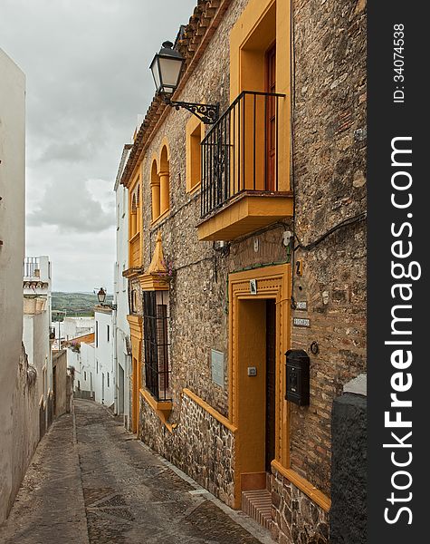 The narrow street with old houses, Arcos de la Frontera, Andalusia, Spain.