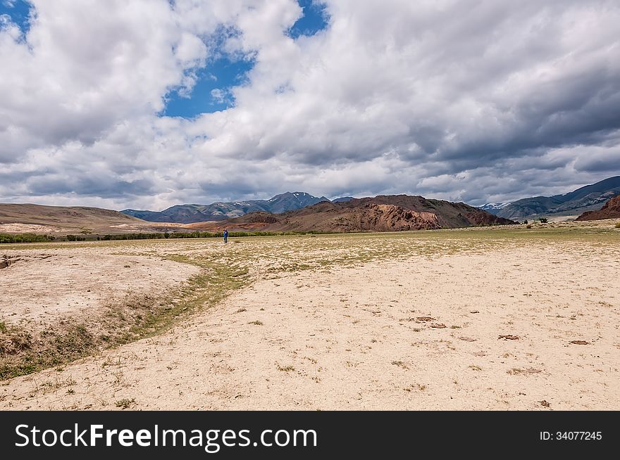 A man photographs the beautiful desert landscape in the mountains. A man photographs the beautiful desert landscape in the mountains.