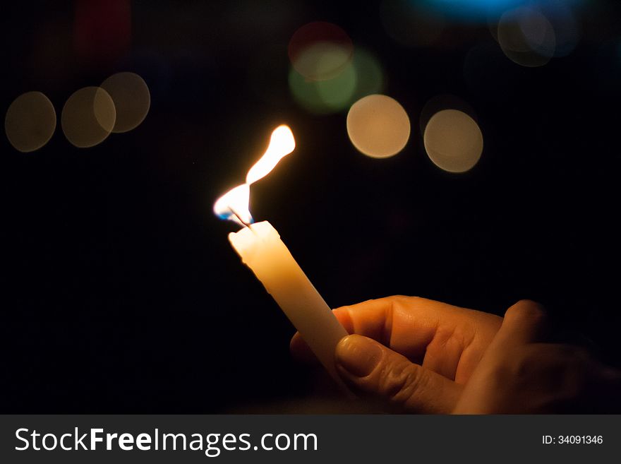 A hand holding a candle during earth hour on Buenos Aires