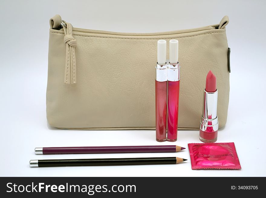 Hiv protection,woman cosmetics mascara, lipstick, eyeliner pencil, womans handbag, protection against hiv, condom