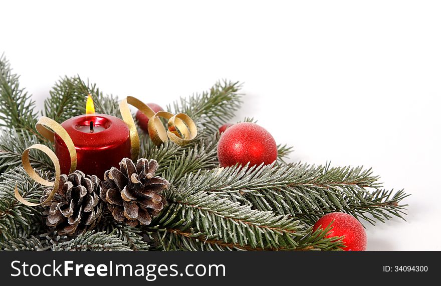 Red candle burning amongst twigs of the spruce. Red candle burning amongst twigs of the spruce