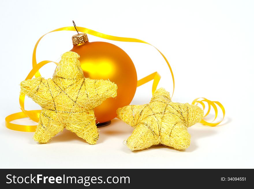 Yellow bauble and yellow stars on the white background