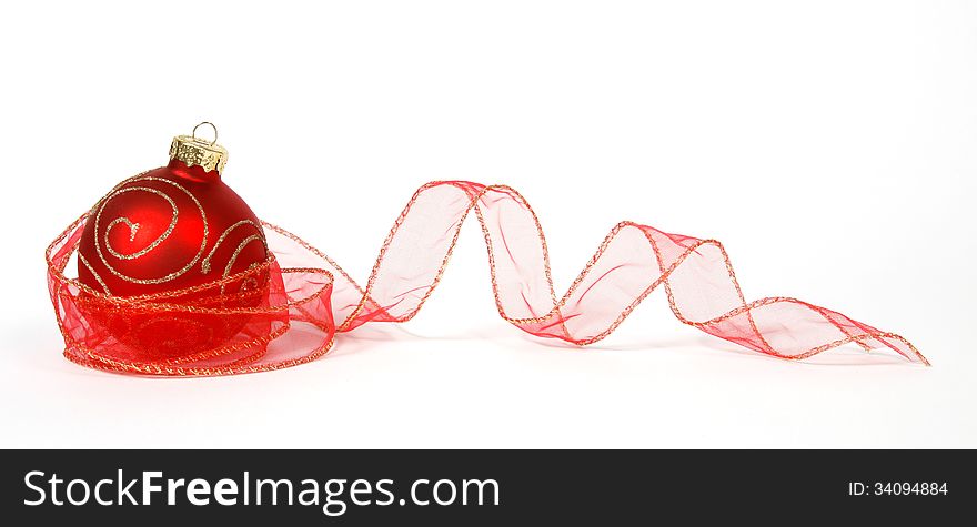 Red-golden bauble with the ribbon on the white background