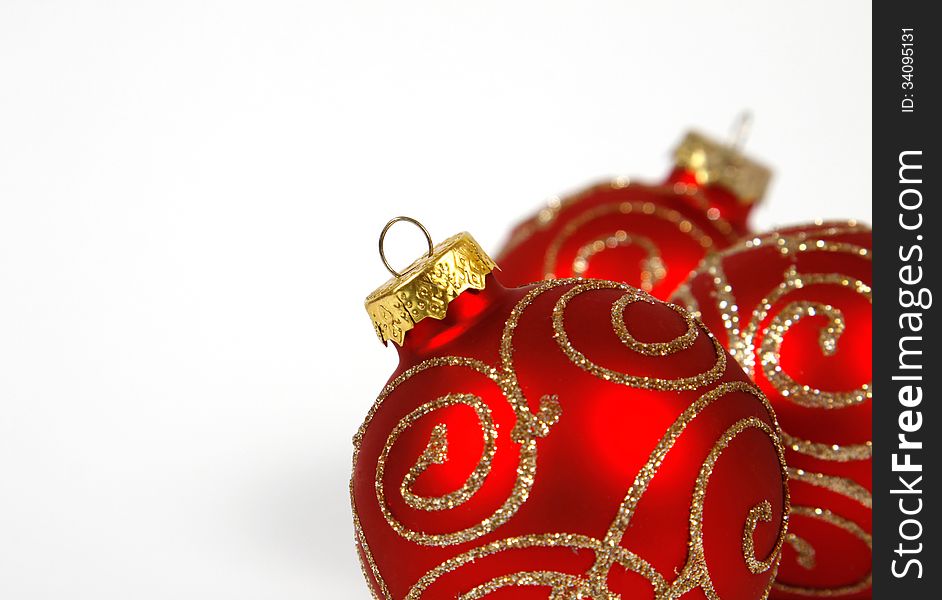 Red-golden baubles on the white background