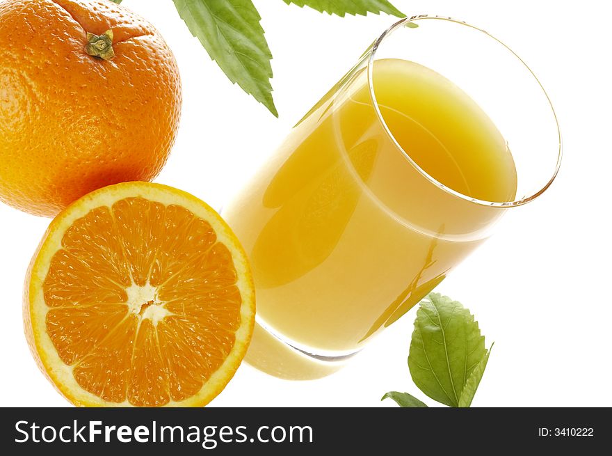 View of nice fresh  oranges and glass of juice beside