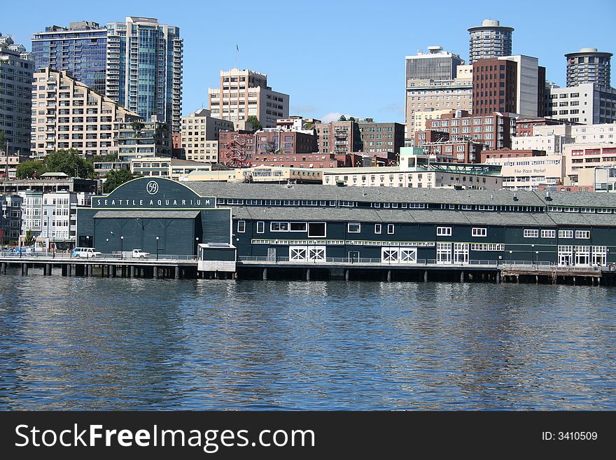 View of Seattle Aquarium where it resides on a pier at the Seattle waterfront. Shot is taken from the water.